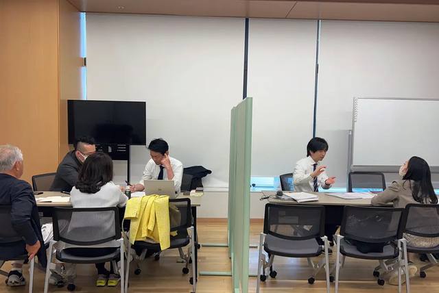 相談会の会場全景。パーテーションで仕切られた複数のテーブルで、同時に個別相談が行われている様子。